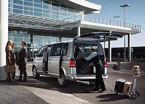 Airport shuttle driver loading luggage